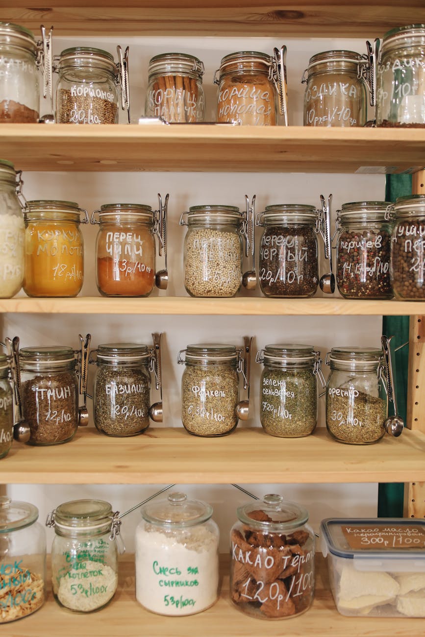 clear glass jars on white wooden shelf